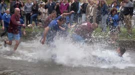 Bizarre Bank Holiday tradition of ‘Football In The River’ takes place in the UK
