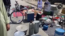 Kabul resident sells household items on roadside to buy food for family amid bank closures