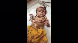 In Indian family celibrate Janmashtami with small children as a lord Krishna