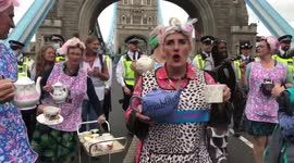 Extinction Rebellion protesters dressed as tea ladies are moved off Tower Bridge by police