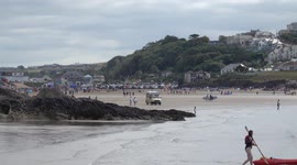 Ice cream van braves the waves to get to isolated beach at Polzeath Cornwall