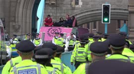 Hundreds of police officers march across Tower Bridge as protestors occupy entire bridge
