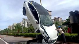 Tesla car smashes through guardrails and falls into ditch after crash in China