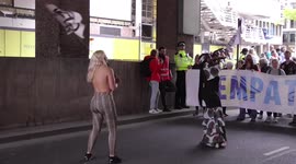 Topless Extinction Rebellion protester shakes her butt to the beat of demonstrators' drums
