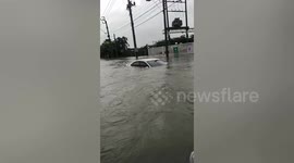 Drowned cars wash away by flash floods after rainstorm in Thailand