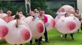 Protesters dressed as giant inflatable breasts protest Facebook's nipple image algorithm