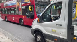 London bus and van in tense stalemate on narrow road in London