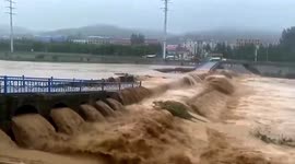 Bridge collapses into rapid floodwater as Chinese city hit by heavy rain