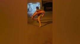 Fit mother plays giant hula hoop to keep in shape