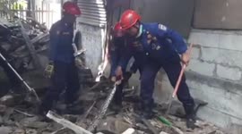 Indonesian firefighters drag 16-foot-long python out of debris near residential building