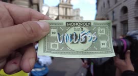 Piers Corbyn is asked if he had dropped some Monopoly money and smiles as he handed it while at Extinction Rebellion's protest