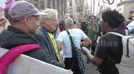 Extinction Rebellion drummers drown out Piers Corbyn as he shouts against Global Warming saying he is a scientist
