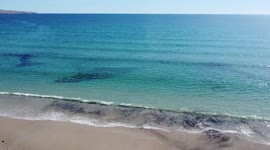 Flying over the sand dunes towards the waves of Sellicks Beach, Fleurieu Peninsula, South Australia