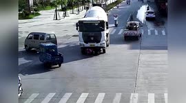 Chinese motorcyclist escapes serious injury after being dragged along road by mixer truck