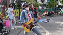 Bands, graffiti and street art as Thai anti-government protest blocks Bangkok road