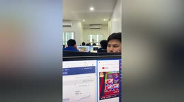 Hungry monkey presses it face against office window to beg for food from workers