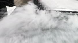 Close-Up View of Person Removing ice covered with snow From His/Her Car