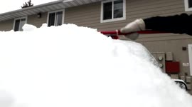 Close-Up View of Person Removing ice covered with snow From His/Her Car