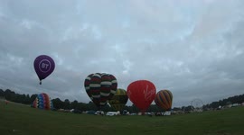 Time-lapse of hot air balloons flying up from racecourse in York, UK