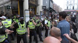 Batons out: Four police officers injured in clashes as 'Anti-vaccine passport' protesters try to storm London venues