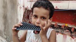 Little cute boy singing piano in funny ways in street