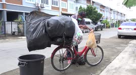A recycle material collector walks my street every day with an overloaded bicycle.