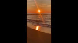 Sunrise on the east coast of Australia at the beach with the waves carrying