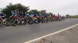 Cyclists race past on first day of Tour of Britain race, from Penzance to Bodmin in Cornwall