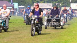 Convoy of classic motorcycles parading around an arena in North Yorkshire