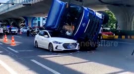 Truck crushes car after flipping over during U-turn in southern China