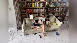 'Supermom' shows perfect reflexes to catch book falling on child's head