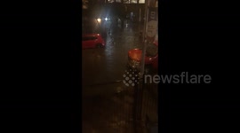 A man on a moped moves along a flooded street in Hoboken, NJ, USA
