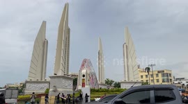 Activists cover monument in anti-government slogans at protest in Thailand