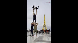 Acrobats perform awesome feat of strength and balance in front of Eiffel Tower