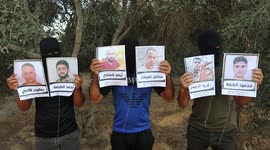 Masked Palestinians prepare balloons with photos of six prisoners who were escaped from an Israeli jail, to be flown towards Israel
