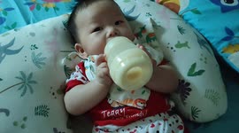 3 months old newborn baby knows to hold milk bottle by herself