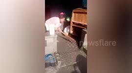 Neighbours rescue old woman from chest-deep flood during Typhoon Conson