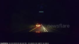 Dashcam footage of passing a slow vehicle with an overloaded trailer at night