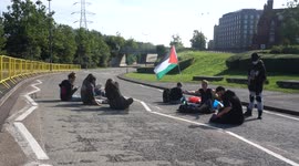 Activists are sleeping at night outside the approach road, the East Gate to block the entrance to the military tractor Excel London Arms Fair