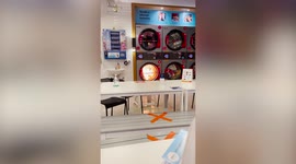 Frantic mother drags toddler to safety as tumble dryer catches fire at laundromat