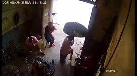 Tyre explodes while being inflated, knocking over man on chair in China
