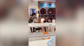 Mother pulls child away from tumble dryer blaze at Thai laundrette
