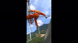 Scared of heights? Look away! Vietnamese electrician repairs power line hundreds of metres above ground