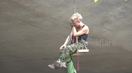Anti-arms activists arrested after abseiling near London weapons fair