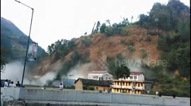 Residents watch on as mountainside collapses due to continuous rainfall in northern China