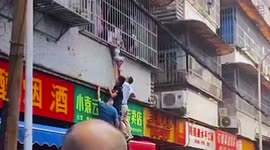 Chinese residents rescue boy hanging from first-floor window