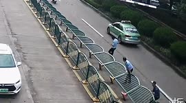 Locals and police team up to lift 100-metre-long barrier blown over by winds in eastern China