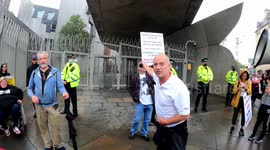 Protesters assemble outside Scotland's Parliament voicing their anger at vaccine passports