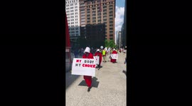 Demonstrators dress as handmaids to protest Texas' restrictive abortion law in Chicago