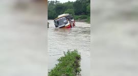 Bus slips amidst overflowing river in central India